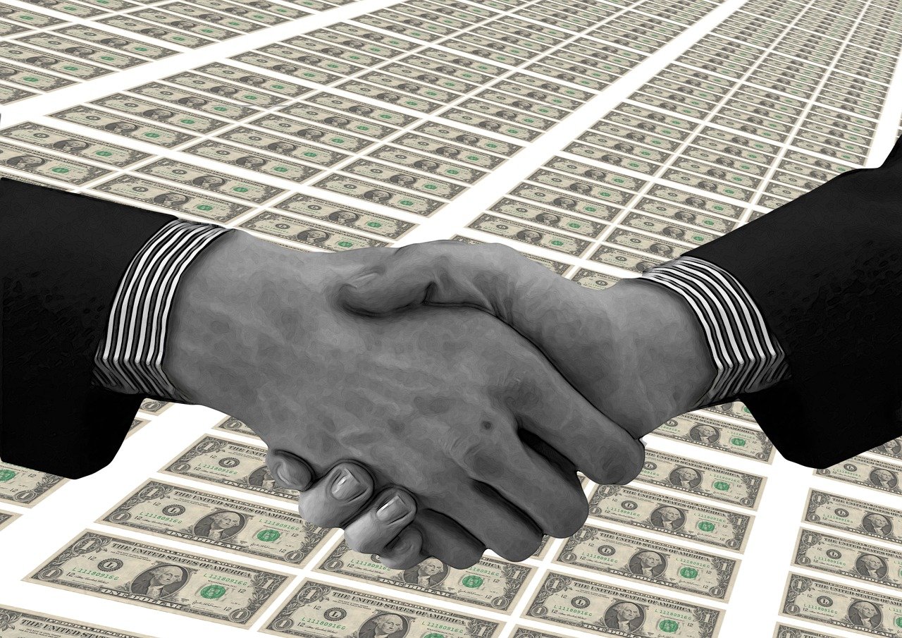 Borrower shaking hands with banker after negotiating a great deal.